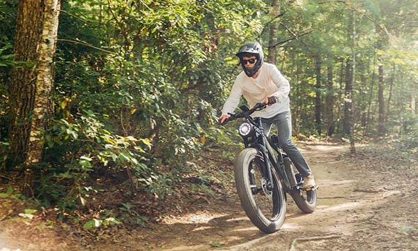 man is riding Brawn fat tire ebike on the moutain road