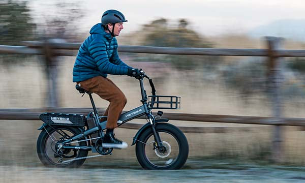 A man is riding the MARS 2.0 folding e-bike quickly