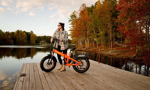 A girl stands next to the Heybike Mars 2.0 Fat Tire e-bike